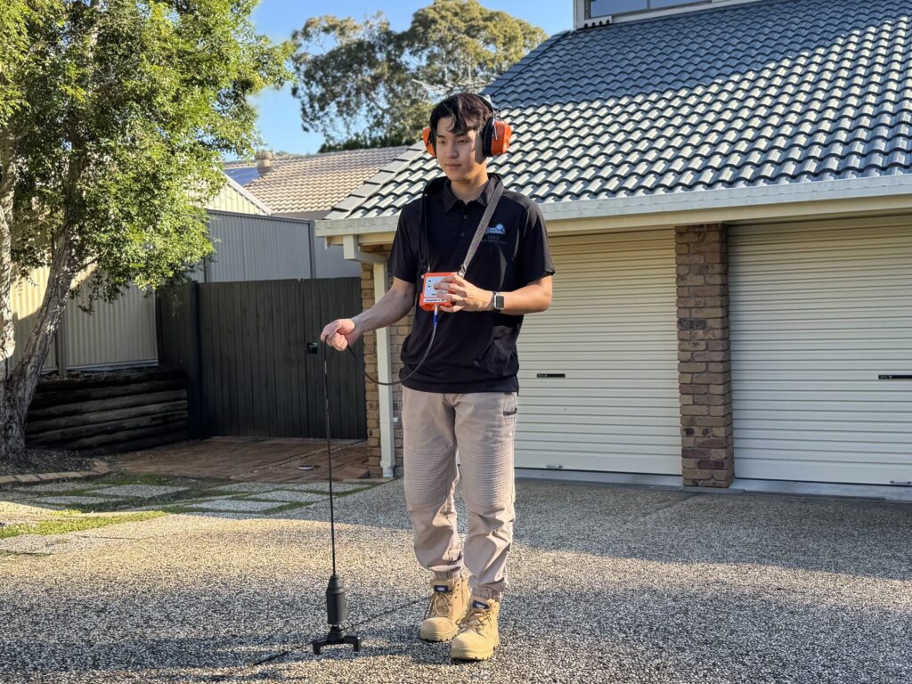 Max Leak Detection technician using acoustic leak detection equipment, servicing Red Hill